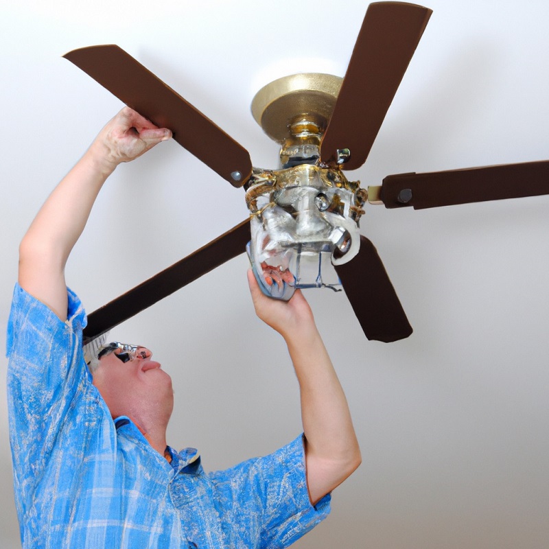 an electrician installing a ceiling fan in Pompano Beach FL