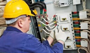 commercial electrician installing electrical panel